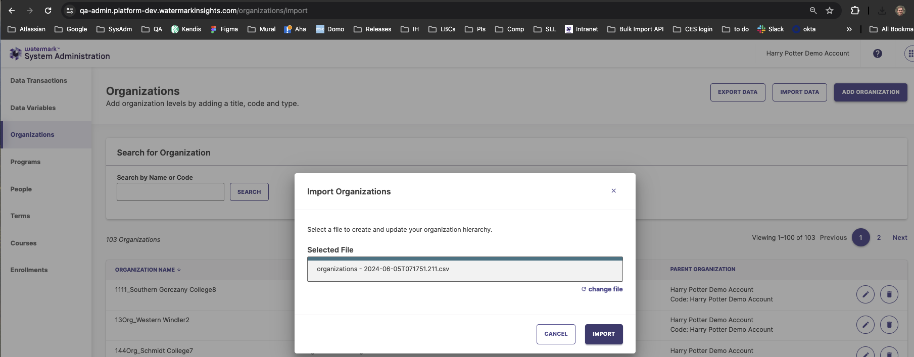 The System Administration interface showing the Organizations page with an 'Import Organizations' modal open. The modal includes options to select and upload a file for import, with Cancel and Import buttons. The background shows organization search and management controls within System Administration.