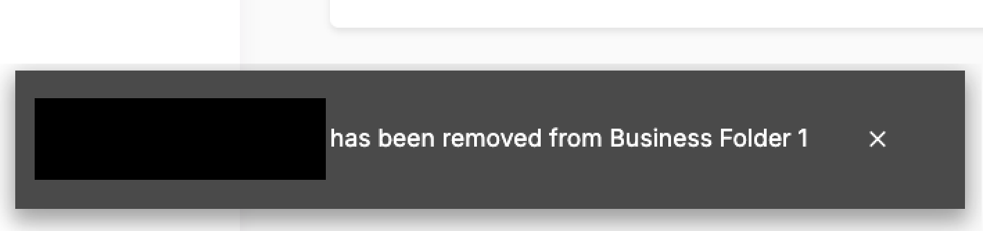 The notification showing message stating the file has been removed from Business Folder 1 with a close button on the right.